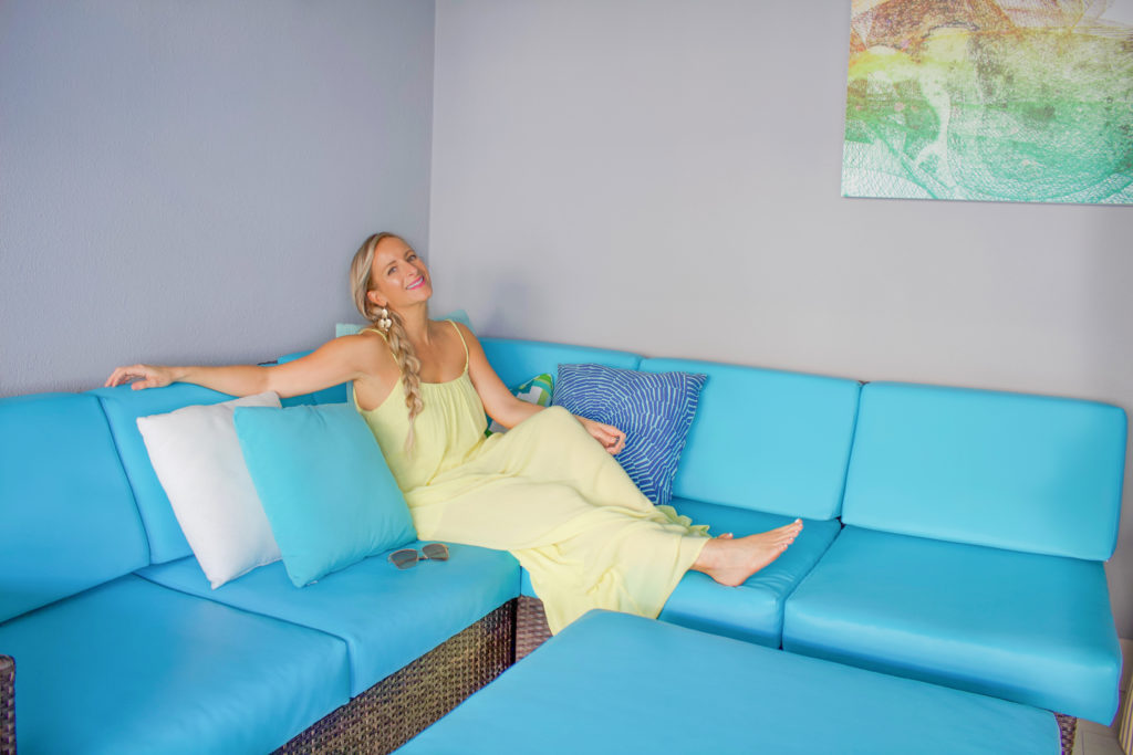 A girl sitting on a blue color couch
