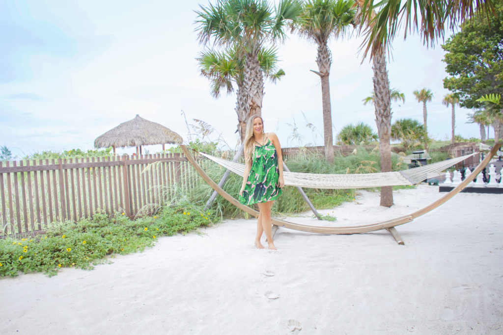 A girl standing near a swing at a beach