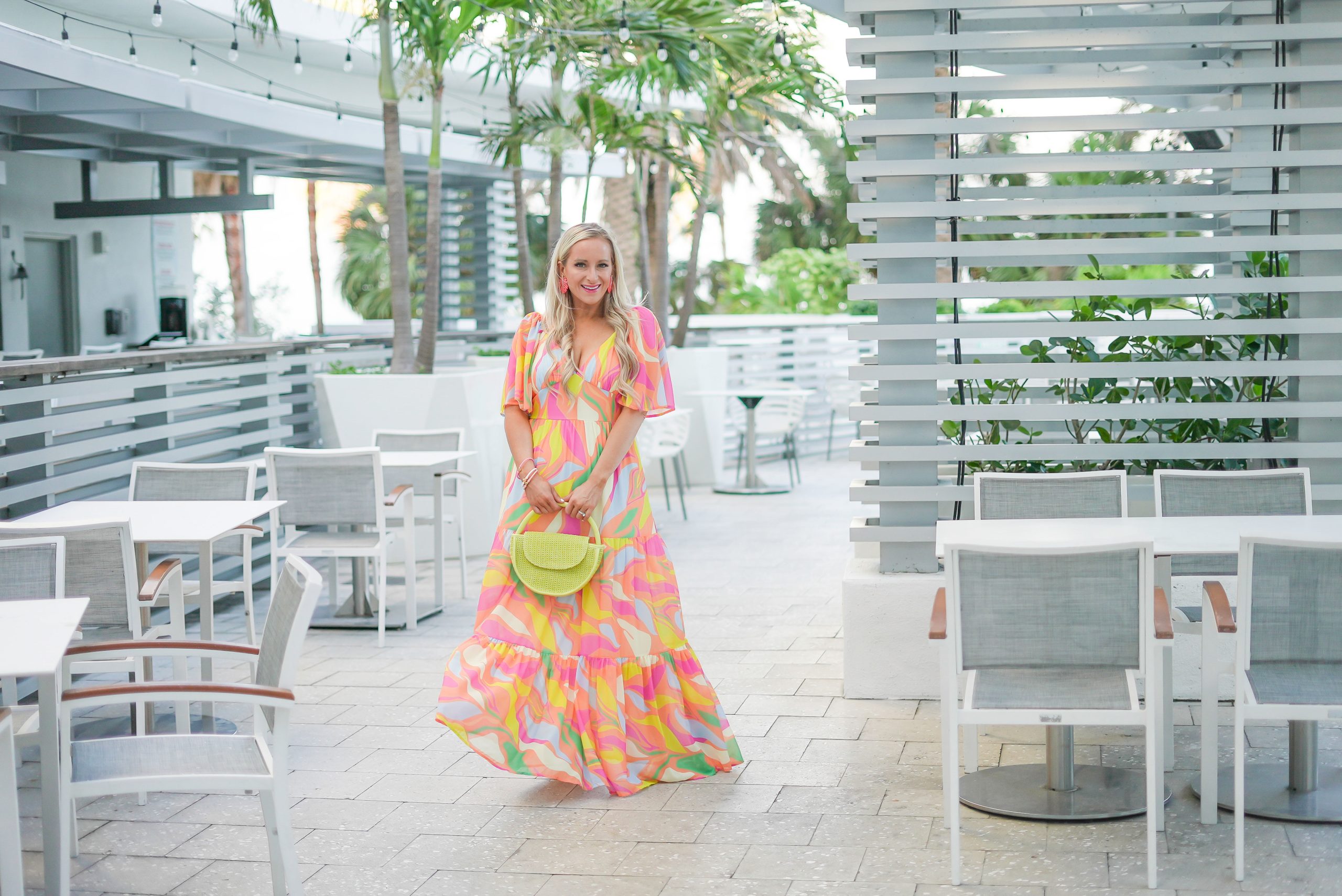 Florida Blogger, Jill DiGioia, The Lovely Flamingo, twirls in a colorful maxi dress at Dock's at Wyndham Grand Clearwater Beach