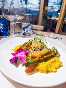 A plate of food on the table with a glass