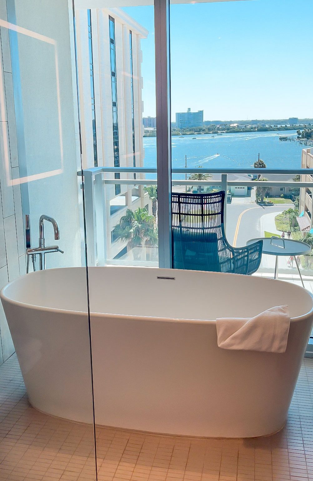 Florida Blogger, The Lovely Flamingo shares a photo of the Wyndham Grand Clearwater Beach Presidential Suite Bathroom with a soaking tub overlooking the inter coastal waters of Clearwater Beach.