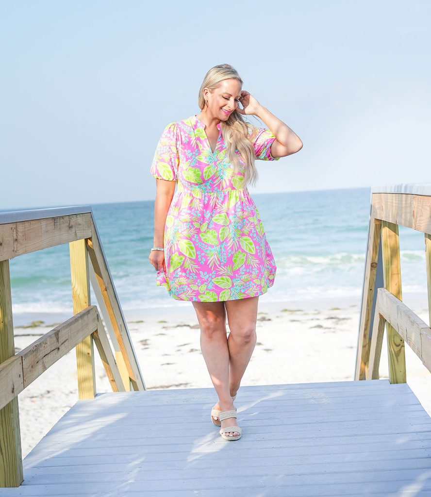 Florida influencer wears a pink palm dress on Treasure Island Beach.
